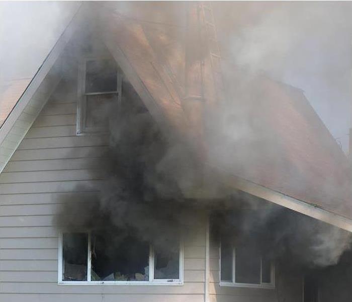 Smoke coming out of a house.